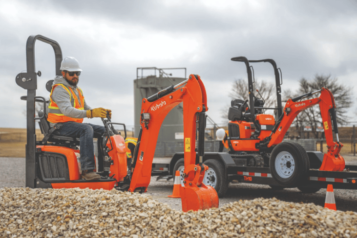 Man operating compact Kubota excavator