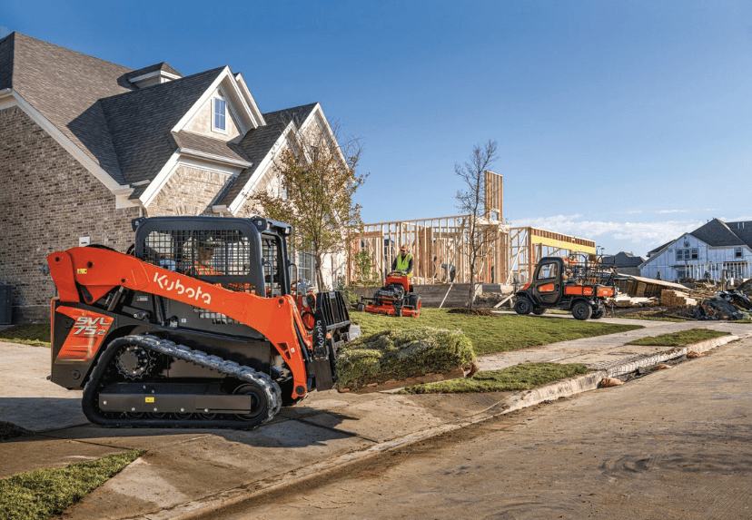 A Kubota SVL75-3 track loader moving a pallet of turf