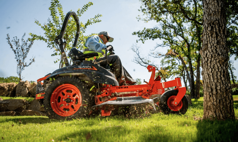 A professional mowing a lawn with a Kubota Zero Turn Mower